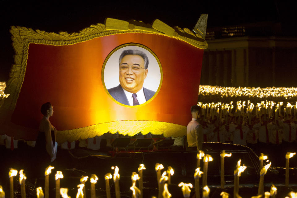 A float with a portrait of late North Korean leader Kim Il Sung passes by North Korean students taking part in a torch light march held in conjunction with the 70th anniversary of North Korea's founding day celebrations in Pyongyang, North Korea, Monday, Sept. 10, 2018. (AP Photo/Ng Han Guan)