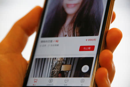 A page of a date-hiring app "Hire Me Plz", which says "rent now for 999 yuan an hour", is shown in this picture illustration in Beijing, China, January 26, 2017. REUTERS/Damir Sagolj/Illustration