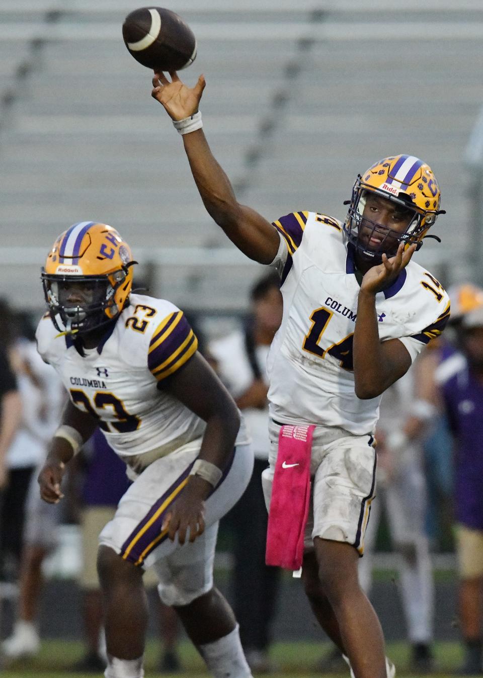 Columbia quarterback Xavier Collins (14) throws a pass as running back Jonathan Andrews (23) blocks during an Oct. 13 game against Middleburg.