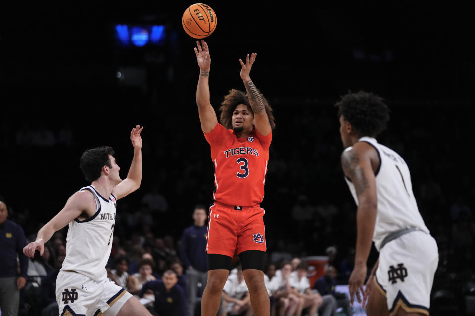 Auburn's Tre Donaldson (3) shoots as Notre Dame's Logan Imes (2) and Julian Roper II (1) watch during the second half of an NCAA college basketball game in the Legends Classic tournament Thursday, Nov. 16, 2023, in New York. (AP Photo/Frank Franklin II)