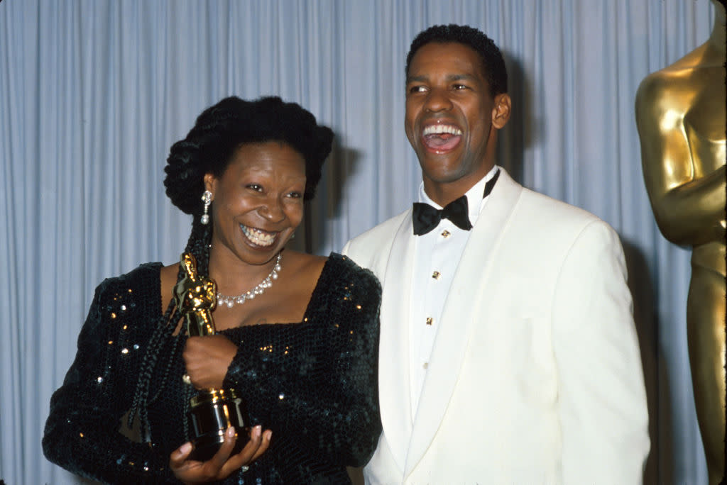 Whoopi Goldberg holds her Oscar while posing with presenter Denzel Washington at the 1991 Academy Awards.  (Photo: Time Life Pictures/DMI/The LIFE Picture Collection via Getty Images)