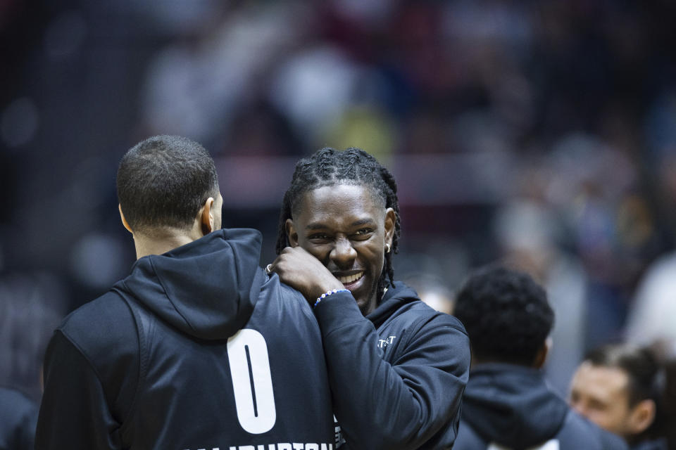 Milwaukee Bucks guard Jrue Holiday laughs with Indiana Pacers guard Tyrese Haliburton during the NBA All-Star 2023 basketball practice Saturday, Feb. 18, 2023 at the Huntsman Center in Salt Lake City. (Ryan Sun/The Deseret News via AP)