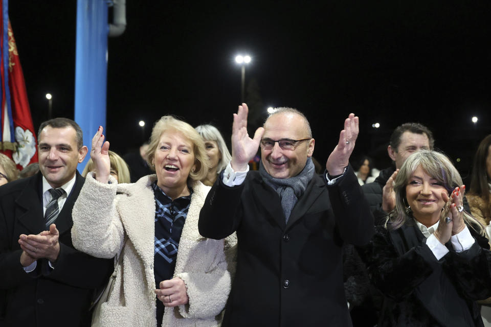 Minister of Foreign and European Affairs Goran Grlic-Radman, center, celebrates after raising the crossing gates at the border in Gorican, Croatia, Sunday, Jan. 1, 2023. More than nine years after Croatia became the European Union's newest member, it is switching to the EU's common currency, the euro, and joining Europe's passport-free travel Schengen area. (AP Photo/Armin Durgut)