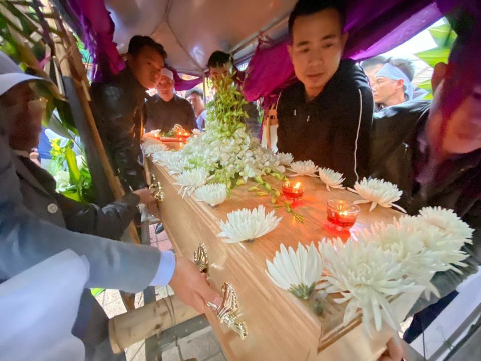 The coffin with the remains of Nguyen Van Hung is loaded onto a hearse during his funeral onThursday, Nov. 28, 2019, in Dien Chau, Vietnam. The 33-year old Hung was among the 39 Vietnamese who died when human traffickers carried them by truck to England in October, and whose remains was among the 16 repatriated to their homeland Wednesday. (AP Photo/Hau Dinh)