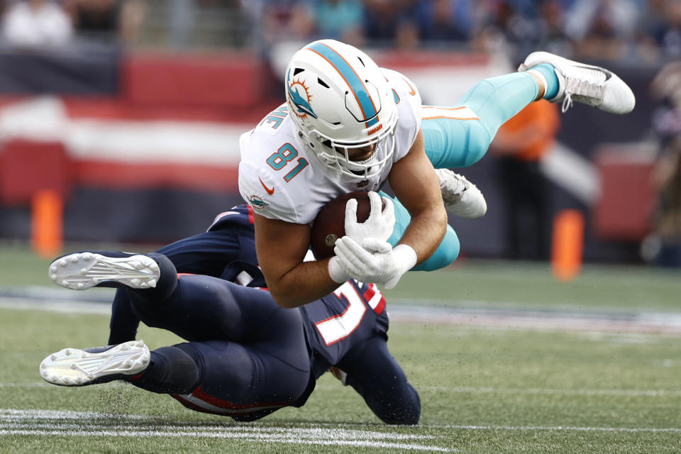 Miami Dolphins tight end Durham Smythe (81) hangs onto the ball while taken down by New England Patriots defensive back J.C. Jackson during the first half of an NFL football game, Sunday, Sept. 12, 2021, in Foxborough, Mass. (AP Photo/Winslow Townson)