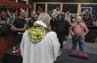 <p>Rev. Jerry Hogan, of the U.S. Conference of Catholic Bishops’ Circus and Traveling Shows Ministry, leads a baptism service for the son of a member of the crew before a Ringling Bros. circus show at the Dunkin Donuts Center, Thursday, May 4, 2017, in Providence, R.I. Hogan’s vestments were made by the costume department from old elephant blankets. (Photo: Julie Jacobson/AP) </p>