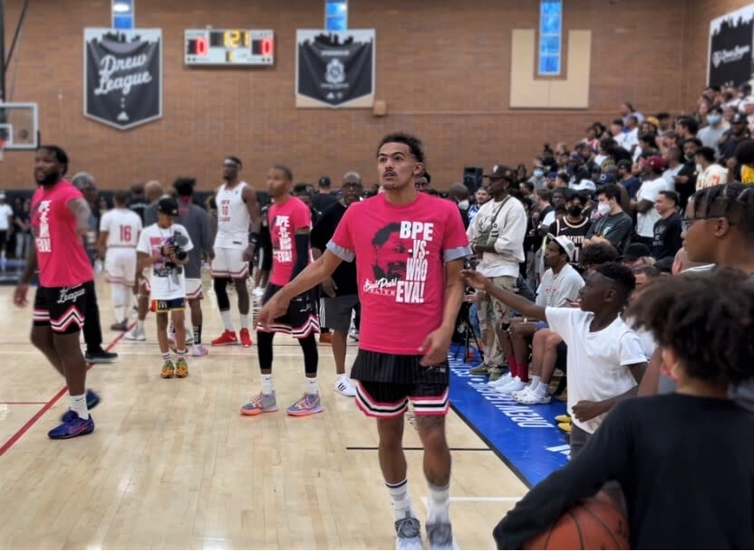 Hawks All-Star guard Trae Young warms up with Black Pearl Elite teammates for a Drew League game Saturday.