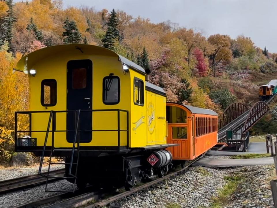 Shot of a yellow and orange train on train tracks