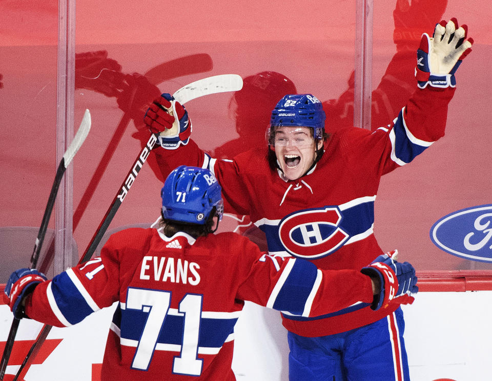 FILE - In this May 1, 2021, file photo, Montreal Canadiens' Cole Caufield (22) celebrates with teammate Jake Evans after scoring against the Ottawa Senators during overtime of an NHL hockey game in Montreal. Caufield was dominating college hockey in late March and by late May was a regular in the lineup of the most storied franchise in the NHL, helping the Canadiens advance to the third round of the playoffs. (Graham Hughes/The Canadian Press via AP, File)