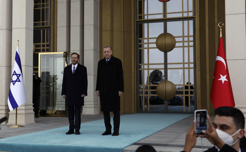 Turkish President Recep Tayyip Erdogan, right, and Israel's President Isaac Herzog pose during a welcome ceremony, in Ankara, Turkey, Wednesday, March 9, 2022. President Isaac Herzog is the first Israeli leader to visit Turkey since 2008. (AP Photo/Burhan Ozbilici)