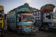 File - In this Wednesday, Sept. 22, 2021 file photo, a truck driver checks his phone at a parking lot in Kabul, Afghanistan. With Afghan assets frozen in the U.S. and the world reluctant to recognize the Taliban, the country's banking system has come to a halt. Unpaid salaries and a brewing humanitarian crisis also put more pressure on the new Taliban government, with no clear way out. (AP Photo/Bernat Armangue, File)