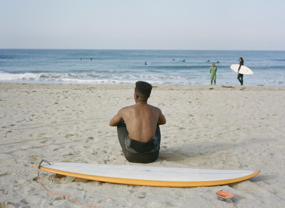 Brick Howze poses for a portrait before a morning surf session on Saturday, March 13, 2021.