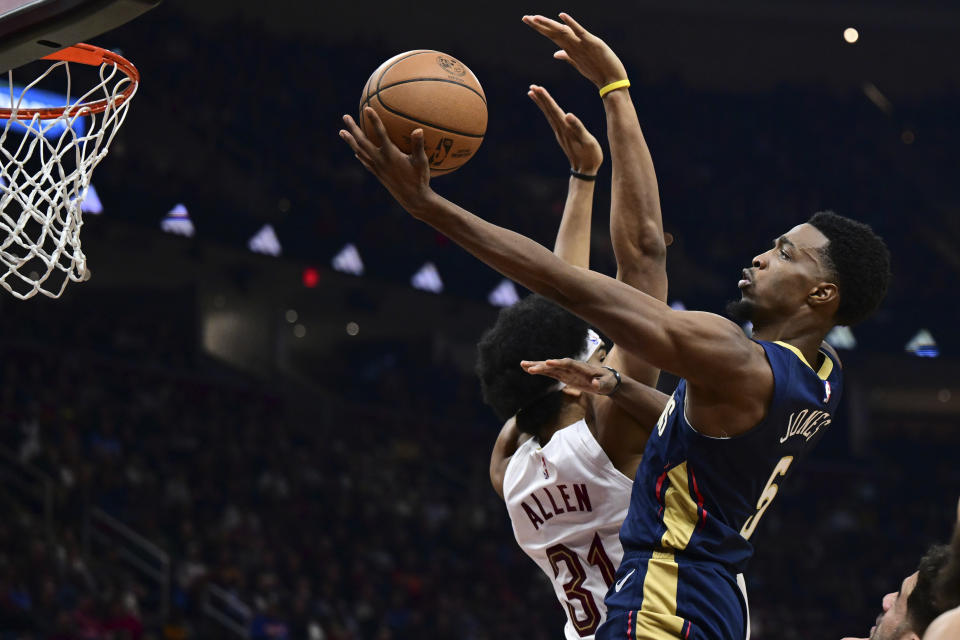 New Orleans Pelicans forward Herbert Jones goes to the basket against Cleveland Cavaliers center Jarrett Allen during the first half of an NBA basketball game, Thursday, Dec. 21, 2023, in Cleveland. (AP Photo/David Dermer)