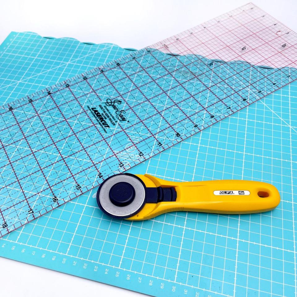 tools needed for quilting, rotary cutter, ruler and self healing cutting mat