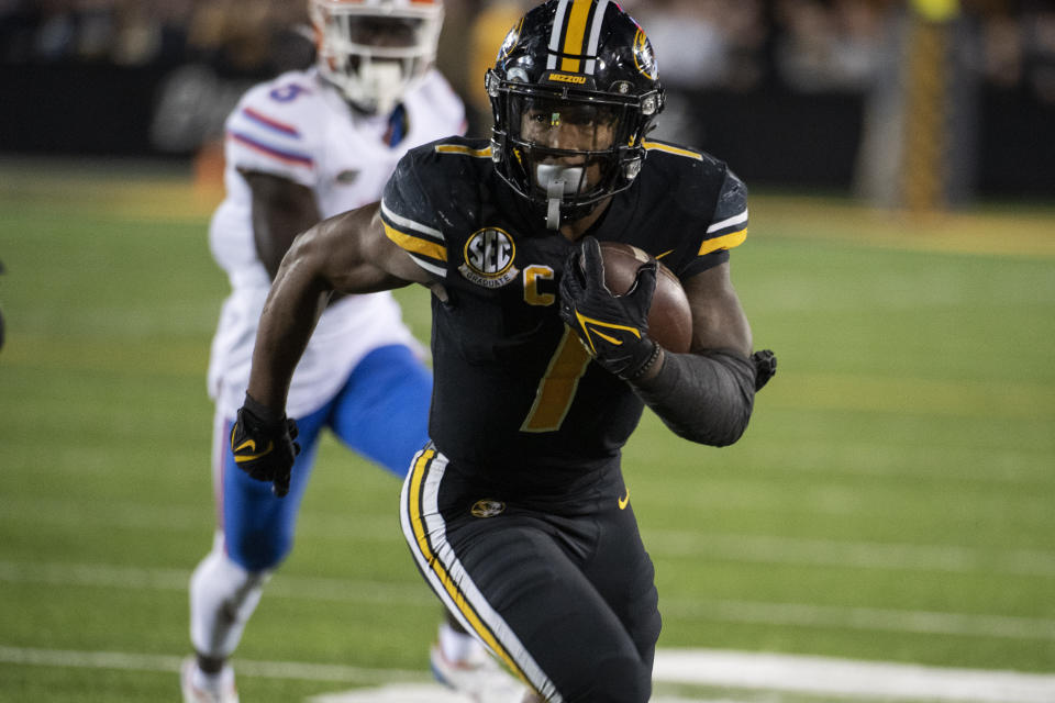 Missouri running back Tyler Badie, right, scores a touchdown during overtime of an NCAA college football game against Florida, Saturday, Nov. 20, 2021, in Columbia, Mo. (AP Photo/L.G. Patterson)