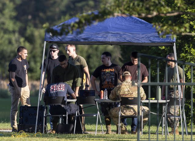 <p>Henry Taylor/The Post And Courier via AP</p> Local law enforcement and airmen from Joint Base Charleston set up a tent and tables to begin coordinating recovery efforts for a stealth fighter jet that crashed in Williamsburg County, S.C., on Monday, Sept. 18, 2023.