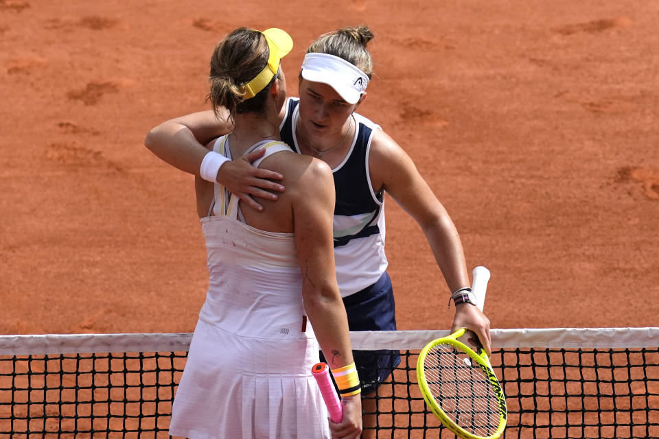 Czech Republic's Barbora Krejcikova, right, hugs Russia's Anastasia Pavlyuchenkova after their final match of the French Open tennis tournament at the Roland Garros stadium Saturday, June 12, 2021 in Paris. The unseeded Czech player defeated Anastasia Pavlyuchenkova 6-1, 2-6, 6-4 in the final. (AP Photo/Christophe Ena)