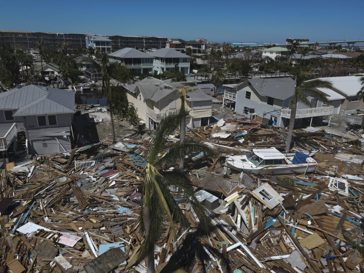 Debris from destroyed buildings swept from the beachfront lies amid damaged homes, two days after the passage of Hurricane Ian, in Fort Myers Beach, Fla., Friday, Sept. 30, 2022. 