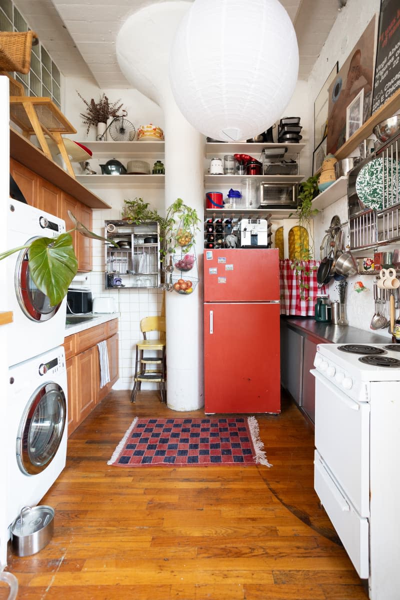 Red refrigerator in eclectic kitchen.