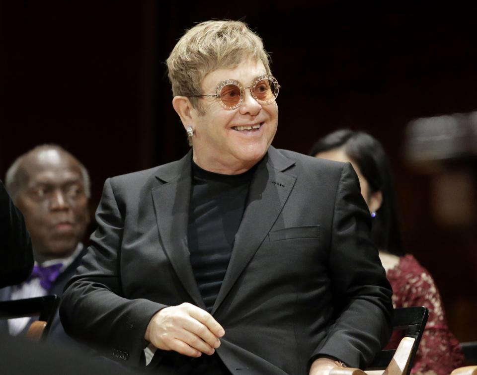 FILE - Musician Elton John smiles as he is introduced before being presented with the 2017 Harvard Humanitarian of the Year Award during ceremonies at Harvard University, in Cambridge, Mass., on Nov. 6, 2017. Elton John is ending the North American leg of his farewell concert tour at L.A.s Dodger Stadium. His three shows start Thursday. The final one, on Sunday, will be shown as a livestream on Disney+. (AP Photo/Steven Senne, File)