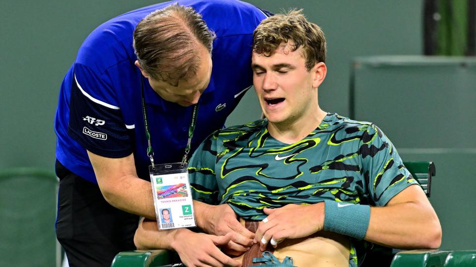 Britain's Jack Draper receives treatment for an abdominal injury before retiring midway through match against Carlos Alcaraz at Indian Wells