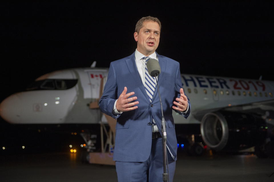 Federal Conservative leader Andrew Scheer comments on a photo from 2001 surfacing of Canadian Prime Minister and Liberal leader Justin Trudeau, when he was a teacher wearing "brownface" at a party, as he makes a statement on the tarmac in Sherbrooke, Quebec, Wednesday, Sept. 18, 2019. (Frank Gunn/The Canadian Press via AP)