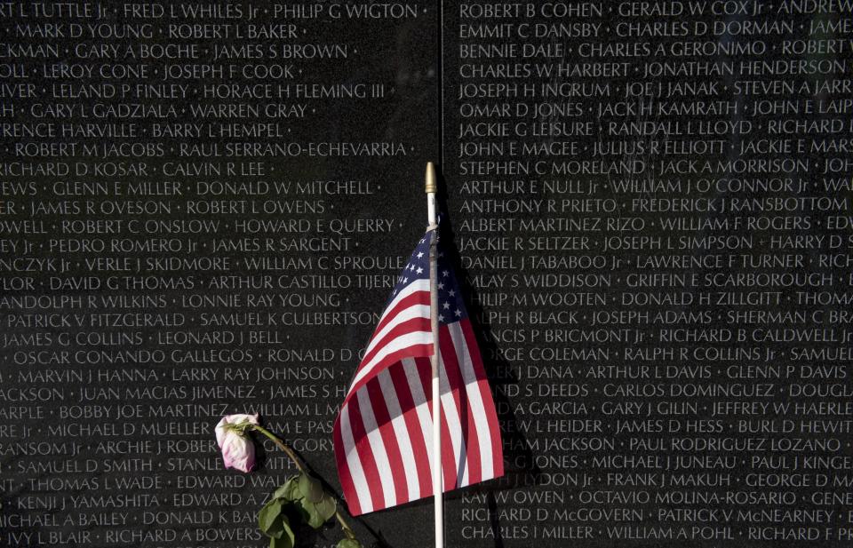 An American flag and flower are seen at the Vietnam Veterans Memorial wall on the National Mall in Washington, D.C. The National Mall will also be the site of the Global War on Terrorism Memorial.