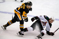 Pittsburgh Penguins' Mike Matheson (5) collides with Arizona Coyotes' Travis Boyd during the first period of an NHL hockey game in Pittsburgh, Tuesday, Jan. 25, 2022. (AP Photo/Gene J. Puskar)