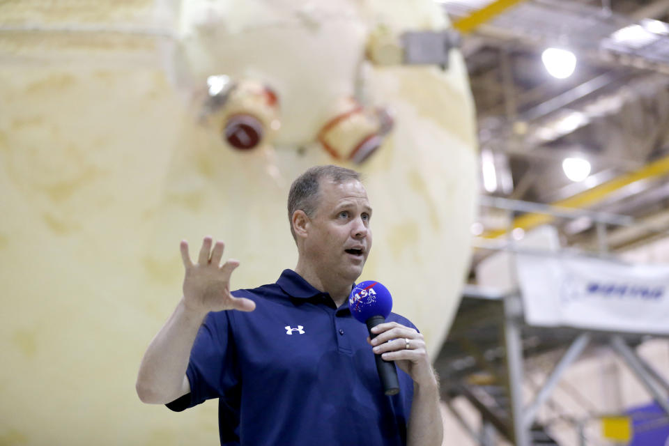 NASA Administrator Jim Bridenstine talks to reporters in front of the core stage of the Space Launch System, which will power the Artemis 1 lunar mission, as he visits the NASA Michaud Assembly Facility in New Orleans, Thursday, Aug. 15, 2019. (AP Photo/Gerald Herbert)