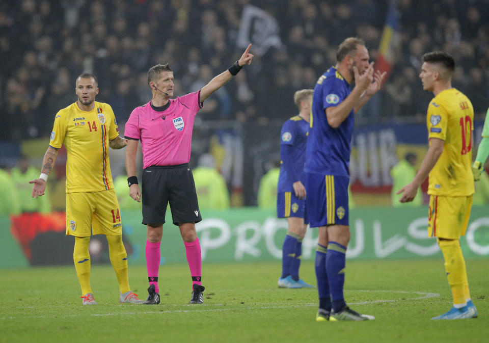 FILE - Referee Daniele Orsato stops the game following alleged racist chants against Sweden's Alexander Isak during the Euro 2020 group F qualifying soccer match between Romania and Sweden on the National Arena stadium in Bucharest, Romania, Friday, Nov. 15, 2019. (AP Photo/Vadim Ghirda, File)