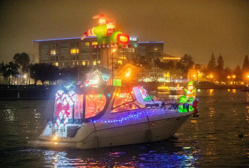 Boats adorned with Christmas lights traverse McLeod Lake at the head of the Deep Water Channel during the Stockton Yacht Club's annual Lynn Hahn Memorial, Delta Reflections Christmas Lighted Boat Parade in downtown Stockton on Saturday, Dec. 3, 2022.