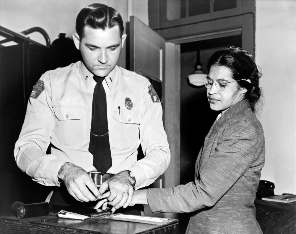 Rosa Parks being fingerprinted after her refusal to move to the back of a bus to accommodate a white passenger kicked off the bus boycott, Montgomery, Alabama,1956.