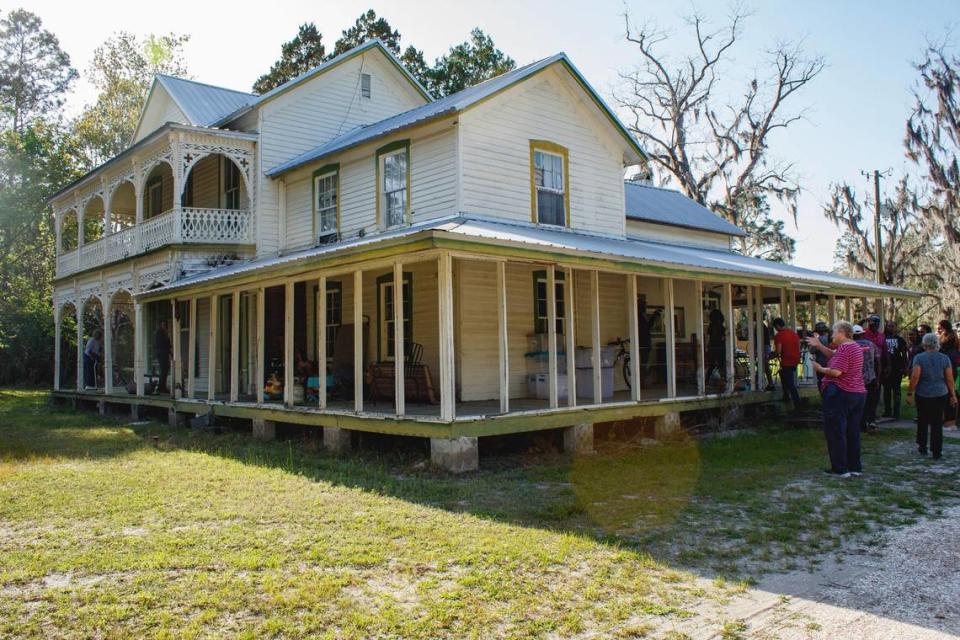 Visitors congregate around the home of John and Mary Jane Wright in Rosewood, Florida, on Sunday, March 5, 2023. The Wrights hid Black women and children inside the attic of their North Florida home when the bloodshed of the 1923 Rosewood Massacre began.