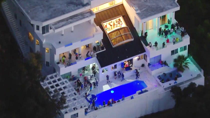 Aerial view of a large house party on Mulholland Drive in Beverly Crest, where three people were shot.