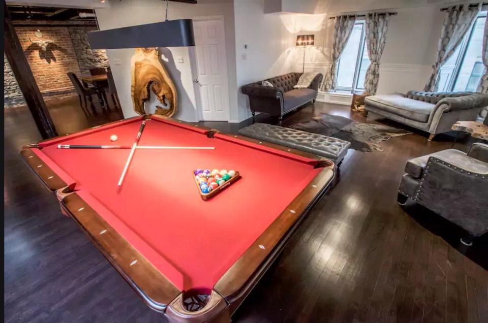 <p>The penthouse loft comes with a pool table, as well as its own foosball table. (Airbnb) </p>