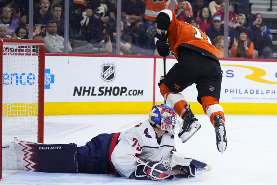 Philadelphia Flyers' Travis Konecny, right, cannot get the puck past Washington Capitals' Charlie Lindgren during the second period of an NHL hockey game, Tuesday, April 16, 2024, in Philadelphia. (AP Photo/Matt Slocum)