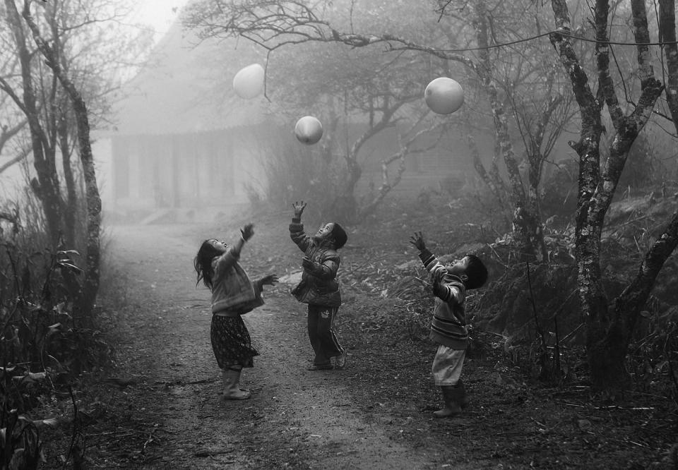 Second Place: H'Mong minority children were playing their ballons on the foggy day in Moc Chau - Ha Giang province Viet Nam Shooting time Jan 2012. (Photo and caption by Vo Anh Kiet/National Geographic Traveler Photo Contest) <br> <br> <a href="http://travel.nationalgeographic.com/travel/traveler-magazine/photo-contest/2012/entries/gallery/winners/" rel="nofollow noopener" target="_blank" data-ylk="slk:Click here to see the National Geographic Traveler's Winners Gallery;elm:context_link;itc:0;sec:content-canvas" class="link ">Click here to see the National Geographic Traveler's Winners Gallery</a>