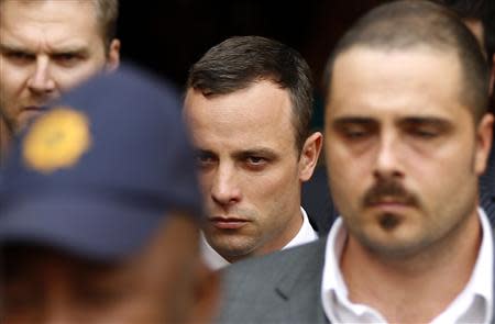 South African Olympic and Paralympic track star Oscar Pistorius (C) leaves after his trial at the high court in Pretoria April 8, 2014. REUTERS/Siphiwe Sibeko