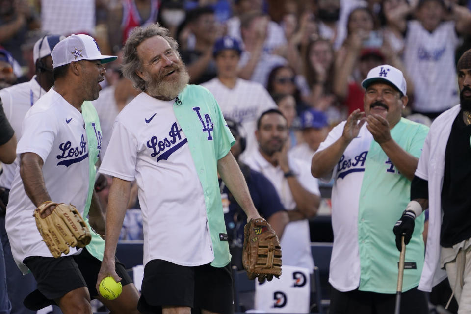 Actor Bryan Cranston smiles after catching a foul ball during the MLB All Star Celebrity Softball game, Saturday, July 16, 2022, in Los Angeles. (AP Photo/Mark J. Terrill)