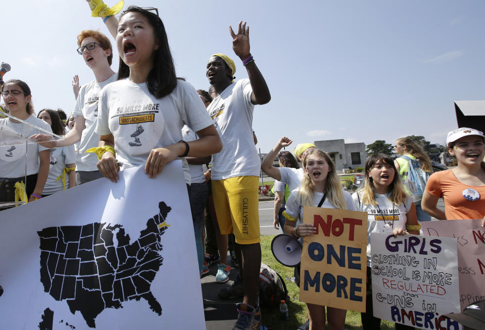 Demonstrators hold placards during a rally in front of the headquarters of gun manufacturer Smith & Wesson following a 50-mile march, Sunday, Aug. 26, 2018, in Springfield, Mass. The march to call for gun law reforms began Thursday, Aug. 23, 2018, in Worcester, Mass., and ended Sunday, in Springfield, with a rally near the gun manufacturer. (AP Photo/Steven Senne)