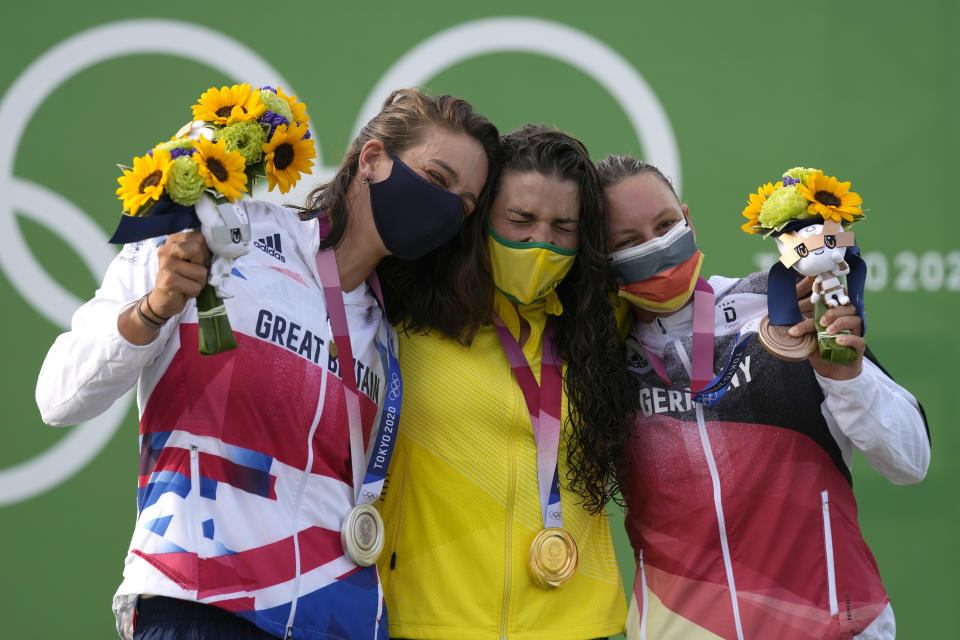 Jessica Fox of Australia, centre, holds the gold medal Mallory Franklin of Britain, left, holds the silver medal and Andrea Herzog of Germany, right, with the bronze medal in the Women's C1 of the Canoe Slalom at the 2020 Summer Olympics, Thursday, July 29, 2021, in Tokyo, Japan. (AP Photo/Kirsty Wigglesworth)