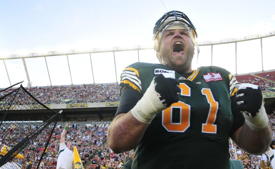 left to right - Edmonton Eskimos player # 61( OL) Kyle Koch celebrates on the Eskimos sidelines at the end of the 4th quarter of CFL game action between the Edmonton Eskimo's and the Toronto Argonauts at Commonwealth stadium in Edmonton June 30/2012 (CFL PHOTO / Walter Tychnowicz)