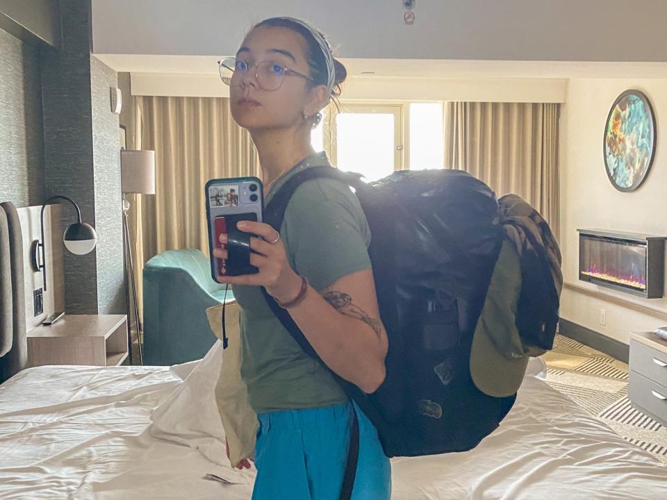 The author wears her backpack in a hotel room