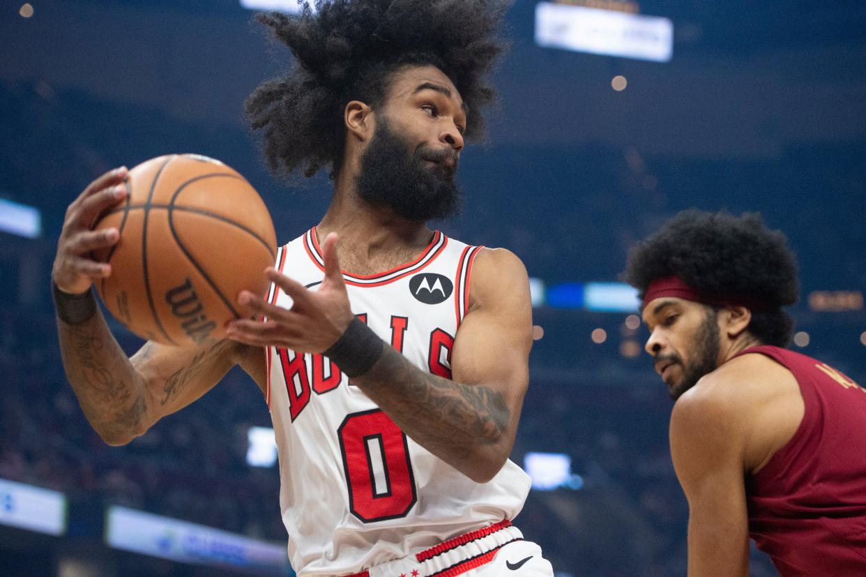 Chicago Bulls' Coby White (0) grabs a rebound in front of Cleveland Cavaliers' Jarrett Allen during the first half of an NBA basketball game Wednesday, Feb. 14, 2024, in Cleveland. (AP Photo/Phil Long)