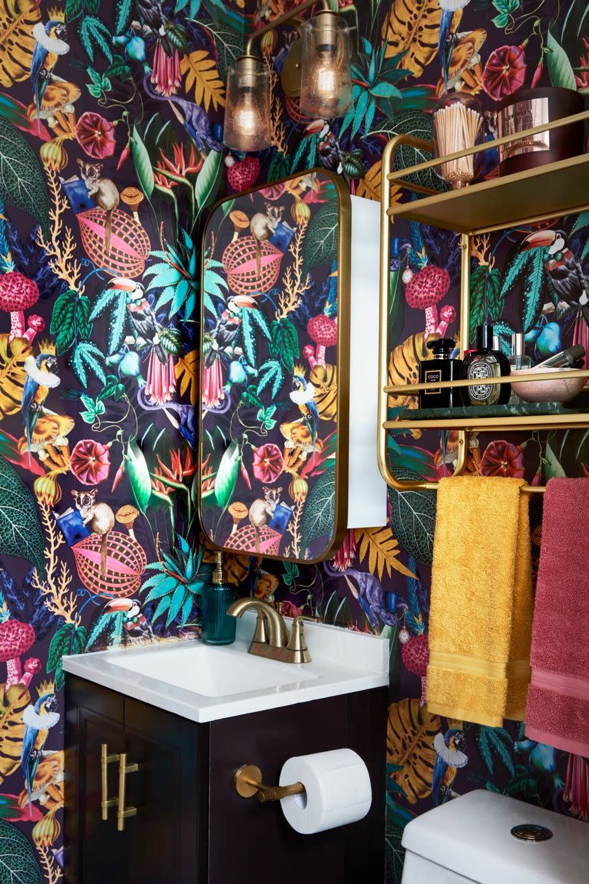 a bathroom with a wall of art