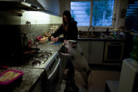 Luciana Benetti, 16, feeds her pet pig Chanchi, given to her for a birthday present the previous year during the COVID-19 pandemic, in Buenos Aires, Argentina, Saturday, Sept. 4, 2021. Chanchi has turned out to be a loyal and loving companion — racing to her side when she fainted. (AP Photo/Natacha Pisarenko)