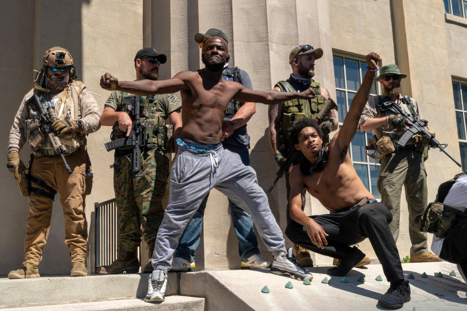 <strong>Louisville, Ky., Sept. 5, 2020.</strong> Protesters taunt militia members who had marched on Breonna Taylor Square.<span class="copyright">Peter van Agtmael—Magnum Photos for TIME</span>