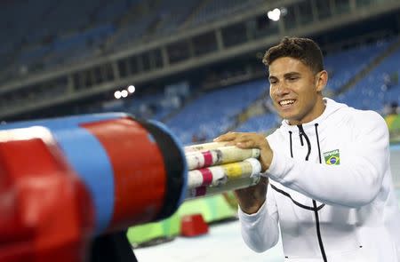 2016 Rio Olympics - Athletics - Final - Men's Pole Vault Final - Olympic Stadium - Rio de Janeiro, Brazil - 15/08/2016. Thiago Braz da Silva (BRA) of Brazil packs his poles after winning gold. REUTERS/Kai Pfaffenbach