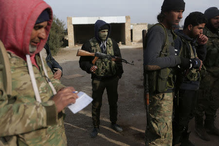 Rebel fighters stand with their weapons on the outskirts of the northern Syrian town of al-Bab, Syria February 8, 2017. REUTERS/Khalil Ashawi