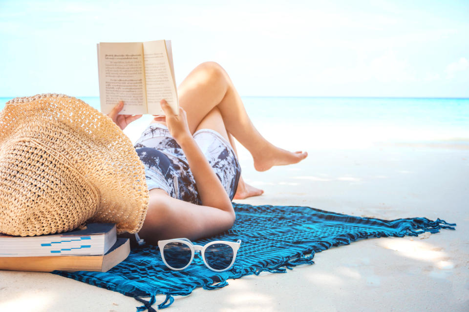 Woman  reading a book on the beach in free time summer holiday